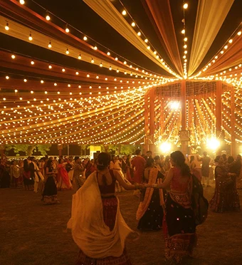 Festival dancers under golden lights
